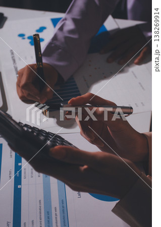 Above table with finance papers, graphs and big data during teamwork meeting with accounting or marketing team discussing budget, strategy or growth development. Closeup of SEO team doing research 138269914