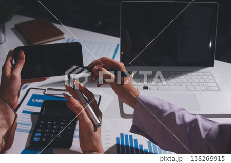 Above table with finance papers, graphs and big data during teamwork meeting with accounting or marketing team discussing budget, strategy or growth development. Closeup of SEO team doing research 138269915