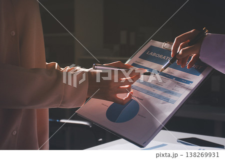 Above table with finance papers, graphs and big data during teamwork meeting with accounting or marketing team discussing budget, strategy or growth development. Closeup of SEO team doing research 138269931
