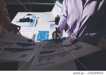 Above table with finance papers, graphs and big data during teamwork meeting with accounting or marketing team discussing budget, strategy or growth development. Closeup of SEO team doing research Above table with finance papers, graphs and big data during teamwork meeting with accounting or marketing team discussing budget, strategy or growth development. Closeup of SEO team doing research 138269933