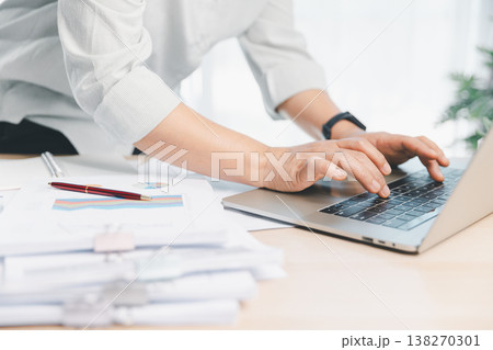 Business professional using calculator and pen reviewing financial report charts on office desk, budgeting and accounting analysis for planning, audit and fintech management workflow. financial report Business professional using calculator and pen reviewing financial report charts on office desk, budgeting and accounting analysis for planning, audit and fintech management workflow. financial report 138270301