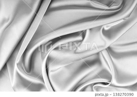 Crumpled, wrinkled white colored glossy silk satin texture. Shiny fabric cloth with wave folds Crumpled, wrinkled white colored glossy silk satin texture. Shiny fabric cloth with wave folds 138270390