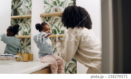 Mother teaching daughter proper oral hygiene brushing teeth Mother teaching daughter proper oral hygiene brushing teeth 138270571