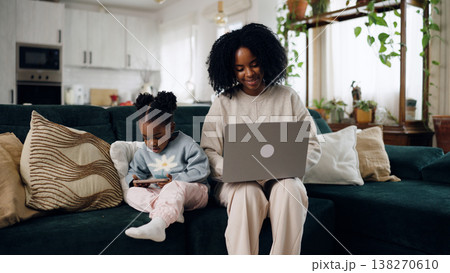 Mother and daughter using technology at home Mother and daughter using technology at home 138270610