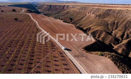 Camper van traveling through Gorafe desert valley in Spain 138270631