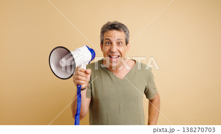 Excited man announcing news using a megaphone Excited man announcing news using a megaphone 138270703