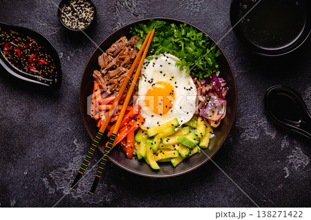 Traditional Korean dish Bibimbap: rice with vegetables beef and egg. 138271422