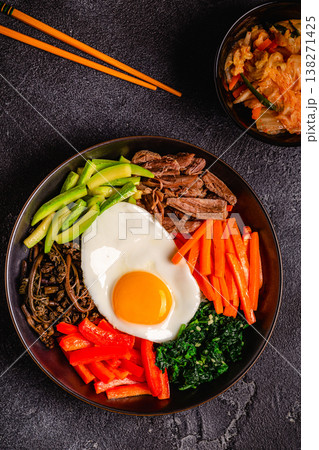 Traditional Korean dish Bibimbap: rice with vegetables beef and egg. Traditional Korean dish Bibimbap: rice with vegetables beef and egg. 138271425