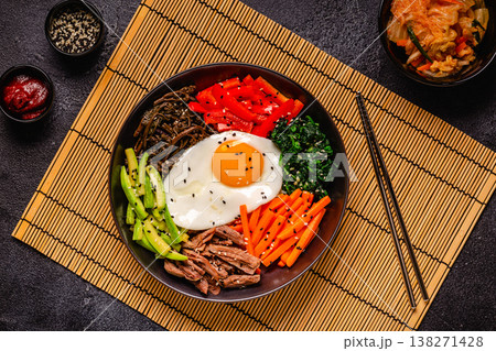 Traditional Korean dish Bibimbap: rice with vegetables beef and egg. Traditional Korean dish Bibimbap: rice with vegetables beef and egg. 138271428