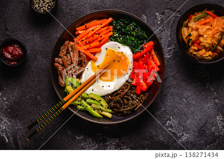 Traditional Korean dish Bibimbap: rice with vegetables beef and egg. Traditional Korean dish Bibimbap: rice with vegetables beef and egg. 138271434
