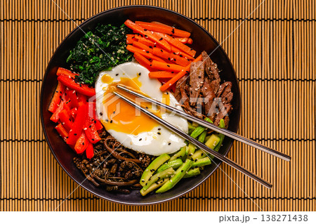 Traditional Korean dish Bibimbap: rice with vegetables beef and egg. 138271438