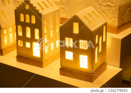 Glowing ceramic miniature houses with warm internal light 138274695