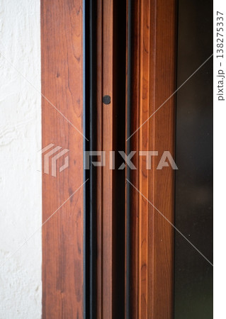 Wooden door frame with intricate moldings and trim details, forming a strong architectural design element, highlighting craftsmanship and traditional joinery Wooden door frame with intricate moldings and trim details, forming a strong architectural design element, highlighting craftsmanship and traditional joinery 138275337