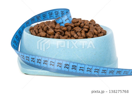 Dry pet food in bowl with measuring tape portion control concept 138275768