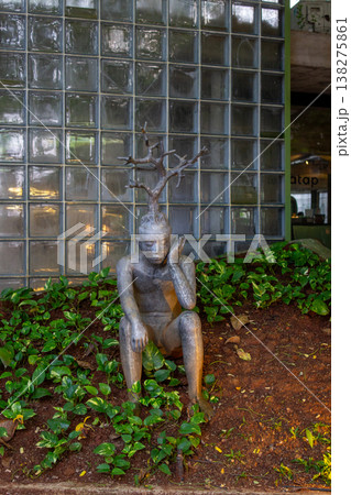 a sculpture of a dragon statue in a garden a sculpture of a dragon statue in a garden 138275861