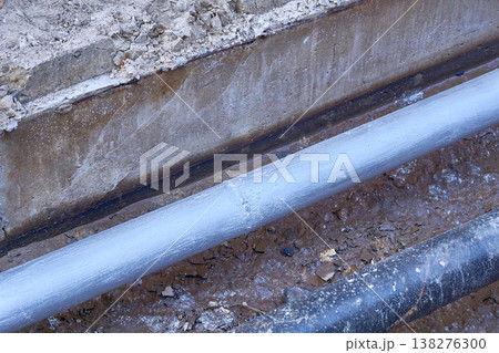 Excavated pit with plastic plumbing sewage pipes for repair and installation 138276300