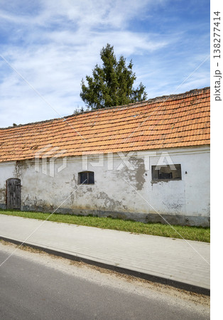 An old farm building in the village, by the road. 138277414