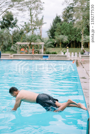 Outdoor swimming pool activity with adult man Outdoor swimming pool activity with adult man 138277530