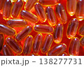 Top view of fish oil capsules on red background forming a bright pattern. Omega 3 supplements and healthcare concept. 138277731