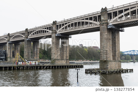 the High Level Bridge rises above the River Tyne as a soaring symphony of wrought iron and weathered stone. Spanning the divide between Newcastle and Gateshead. 138277854