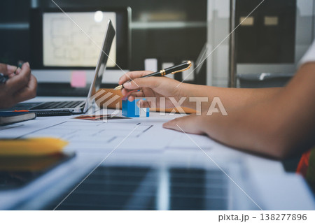 engineer and an architect reviewing blueprints and construction plans together at a bustling construction site engineer and an architect reviewing blueprints and construction plans together at a bustling construction site 138277896