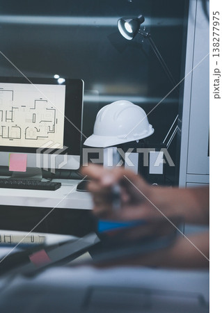 engineer and an architect reviewing blueprints and construction plans together at a bustling construction site engineer and an architect reviewing blueprints and construction plans together at a bustling construction site 138277975