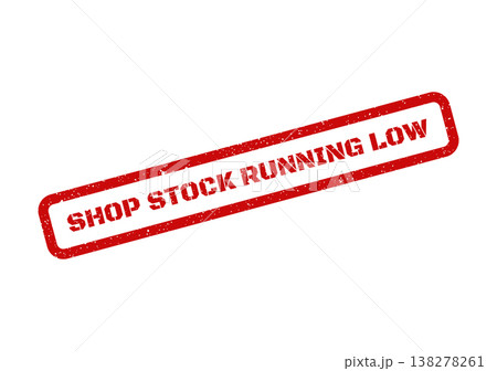 Rectangular red rubber stamp with grunge effect displaying shop stock running low for urgent inventory alerts 138278261