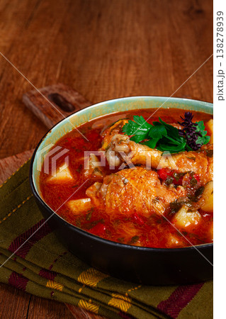 Souzi soup. Georgian dish, meat with oats, tomato sauce and herbs, on a wooden table 138278939