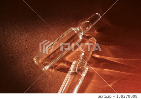 Two clear glass medical ampoules displaying pharmaceutical research Two clear glass medical ampoules displaying pharmaceutical research 138279009
