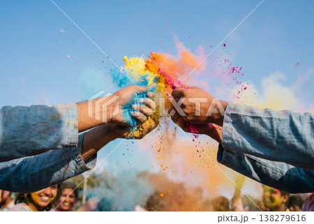 Hands throwing vibrant multi colored powder in celebration 138279616