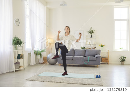 Senior Woman Doing Stretching Exercises at Home for Fitness and Health Senior Woman Doing Stretching Exercises at Home for Fitness and Health 138279819