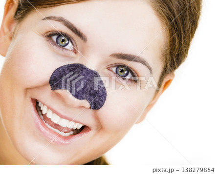 Woman applying pore strips on nose Woman applying pore strips on nose 138279884