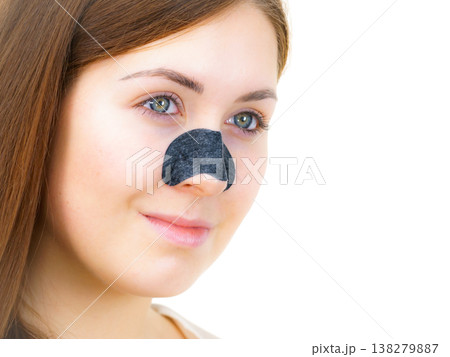 Woman applying pore strips on nose Woman applying pore strips on nose 138279887