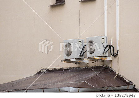 air conditioning on facade of building, air cooling in hot weather. air conditioning on facade of building, air cooling in hot weather. 138279948