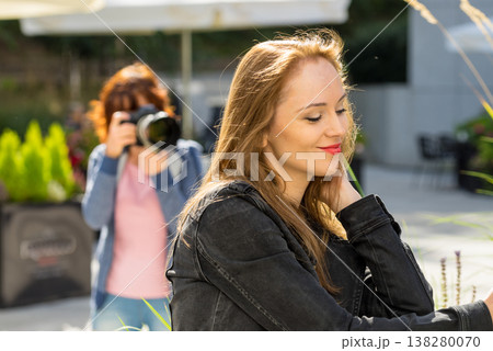 Photographer taking pictures of woman outdoor Photographer taking pictures of woman outdoor 138280070
