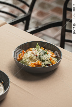 Shrimp salad with parmesan cheese in bowl 138280094