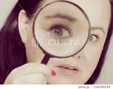 Adult woman with magnifying glass Adult woman with magnifying glass 138280248