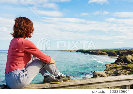 Woman visiting Cathedral Beach in Spain. 138280604