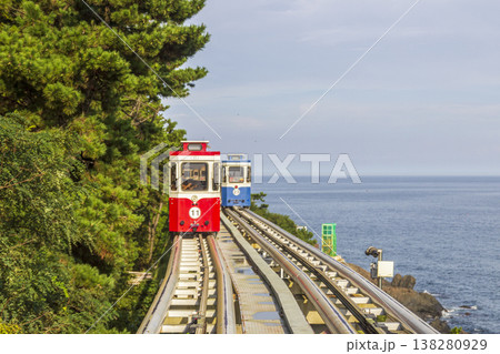Colorful oceanfront capsule cars travel along an elevated coastal rail, offering scenic seaside views and a relaxed tourism experience over the water. High quality photo Colorful oceanfront capsule cars travel along an elevated coastal rail, offering scenic seaside views and a relaxed tourism experience over the water. High quality photo 138280929
