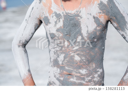 Applying Clay Mud on Skin at Coastal Beach for Relaxation and Treatment During Sunny Day Applying Clay Mud on Skin at Coastal Beach for Relaxation and Treatment During Sunny Day 138281113
