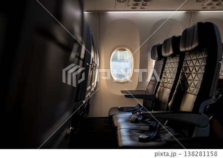 Empty Airplane Cabin With Leather Seats and a View of the Runway During Boarding Process Empty Airplane Cabin With Leather Seats and a View of the Runway During Boarding Process 138281158