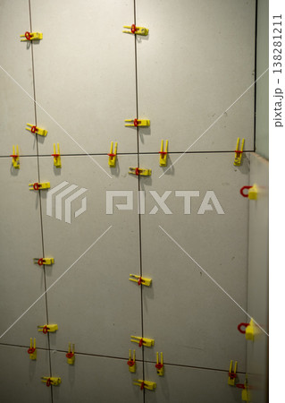 Wall Installation With Tile Spacers in a Modern Setting During a Renovation Project 138281211