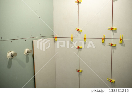 Wall Renovation Project in Progress With Clamps Securing Panels Together in a Construction Space 138281216