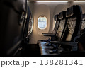 Empty Airplane Seats With a View of Clouds Outside the Window During a Flight at Sunset 138281341