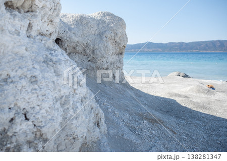 Bright Day at a Calm Beach With Rocky Formations and Serene Blue Waters in the Background 138281347