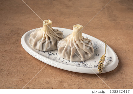 Khinkali dumplings on plate with spices closeup 138282417