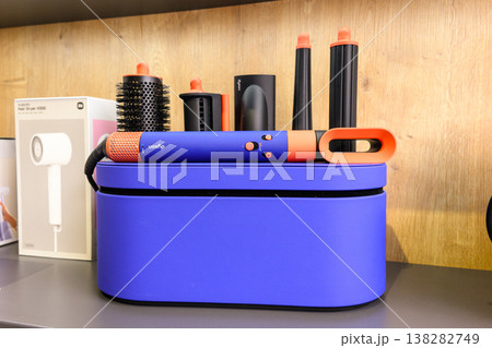 Blue curling iron sits atop its case Blue curling iron sits atop its case 138282749