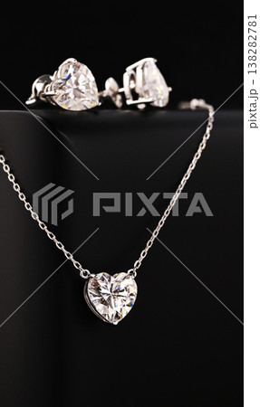 A set of diamond jewelry including a necklace and earrings A set of diamond jewelry including a necklace and earrings 138282781