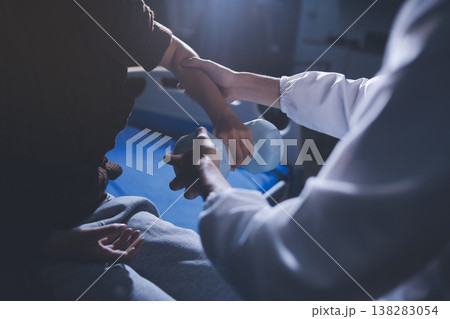 Old woman training with physiotherapist using dumbbells at home. Therapist assisting senior woman with exercises in nursing home. Elderly patient using dumbbells with outstretched arms. Old woman training with physiotherapist using dumbbells at home. Therapist assisting senior woman with exercises in nursing home. Elderly patient using dumbbells with outstretched arms. 138283054