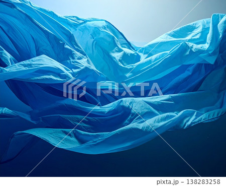ブルーの抽象ファブリック背景 波のような布の流れと光のグラデーション素材 138283258
